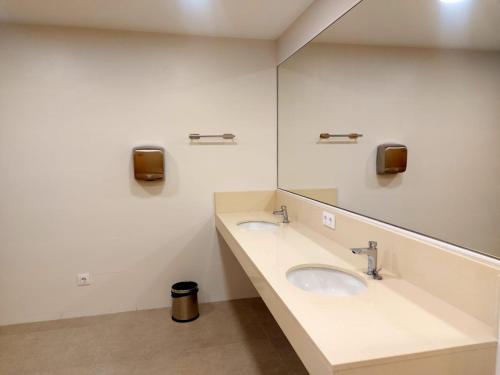 a bathroom with two sinks and a large mirror at Boat Barcelona Yacht in Barcelona