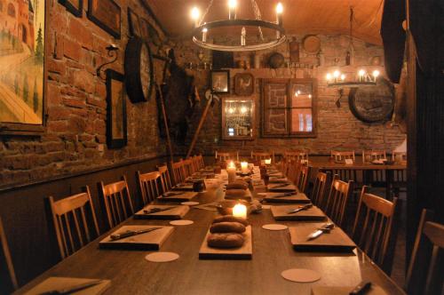 a long table in a restaurant with candles on it at Gasthaus & Hotel Drei Lilien in Werbach