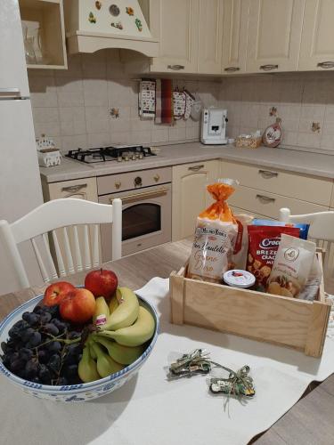 a kitchen with a bowl of fruit and a box of food at Villa Etna Masi' in Milo