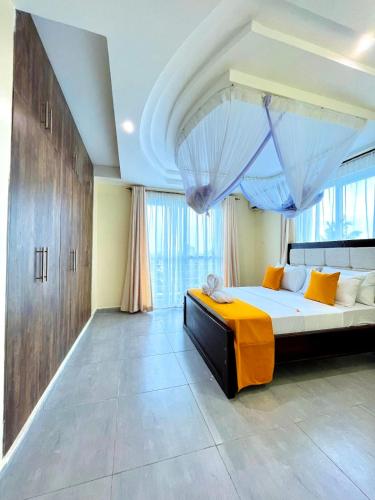 a bedroom with a large bed with a canopy at Nitro Homes Nyali in Mombasa