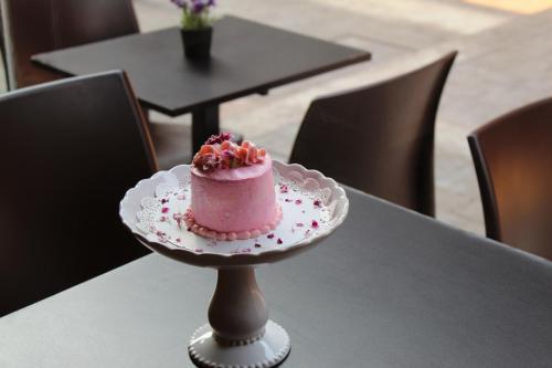 a pink cake sitting on top of a table at Luxury Home Stay - Lajpat Nagar in New Delhi