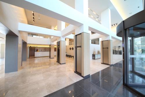 an empty lobby of a building with white columns at Avonhotel Gunsan in Gunsan