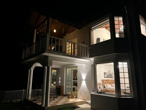 a house at night with a dog sleeping on the floor at Villa MYSA in Rāmgarh