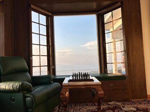 a living room with a chess board and a window at Villa MYSA in Rāmgarh