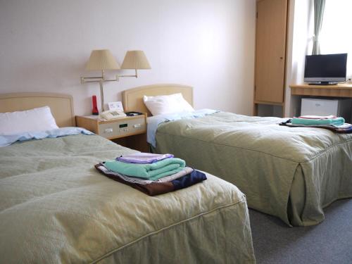 En eller flere senge i et værelse på KKR Kawayu