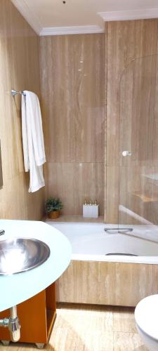 a bathroom with a tub and a sink and a shower at LA ERMITA in Zamora