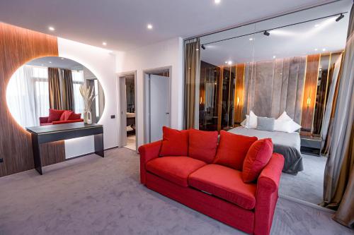 a bedroom with a red couch and a bed at Vila Time Olimp in Olimp