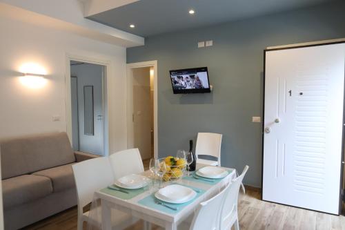 a dining room with a white table and white chairs at SUNSEA - Enjoy Your Family in Capo Vaticano