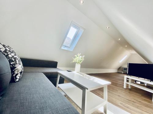 a living room with a couch and a table at Business Apartment ZIMMERzuVERMIETEN in Wangen an der Aare in Wangen an der Aare