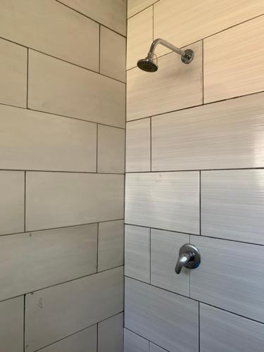 a bathroom with a shower with a shower head at Victoria guest house Nyumbani in Tzaneen