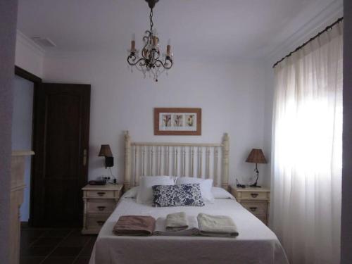 1 dormitorio con 1 cama con 2 toallas en El Magnolio, en Chiclana de la Frontera