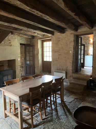 une salle à manger avec une table et des chaises en bois dans l'établissement Charmante maison périgourdine, à Granges-dʼAns