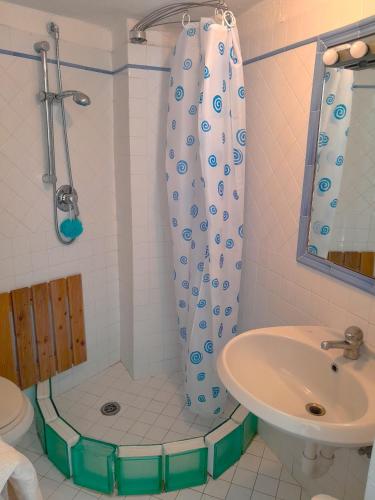 a bathroom with a shower and a toilet and a sink at Casa Marina in Forio d'Ischia