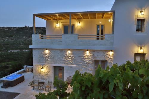 a villa with a swimming pool at night at Amvikas suites-Sitia in Sitia
