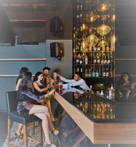 a group of people sitting at a bar at Zone By The Park Gopalpur in Gopālpur