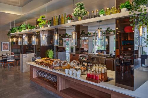 a bakery with a counter with pastries on it at Zone By The Park Gopalpur in Gopālpur