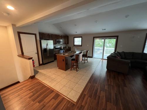 a living room with a couch and a kitchen at Luxury Beach Side Home home in North Camellia Acres