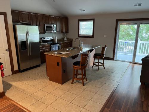 a kitchen with a refrigerator and a table and chairs at Luxury Beach Side Home home in North Camellia Acres