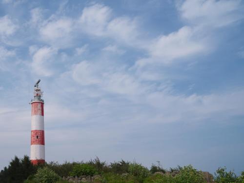a lighthouse with a bird sitting on top of it at Zone By The Park Gopalpur in Gopālpur
