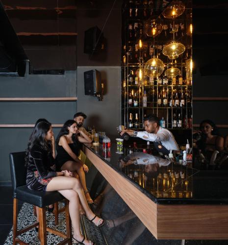 a group of people sitting at a bar at Zone By The Park Gopalpur in Gopālpur