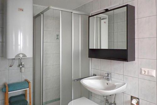 a small bathroom with a sink and a mirror at Ferienwohnungen Raczkowski in Birkfeld