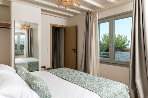 a bedroom with a bed and a window at Amvikas suites-Sitia, by Comfortbnb in Sitia