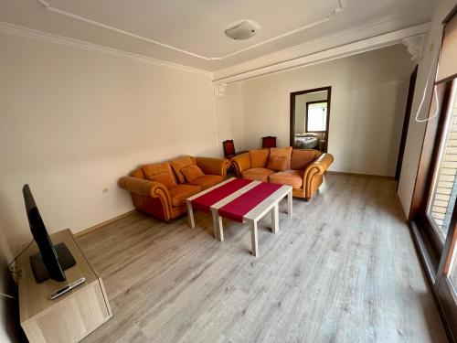 a living room with a couch and a table at Home Base Apartments in Skopje