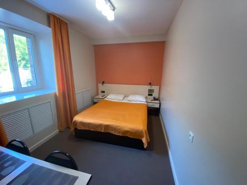 a small room with a bed and a window at Ulpan Mini Hotel in Astana