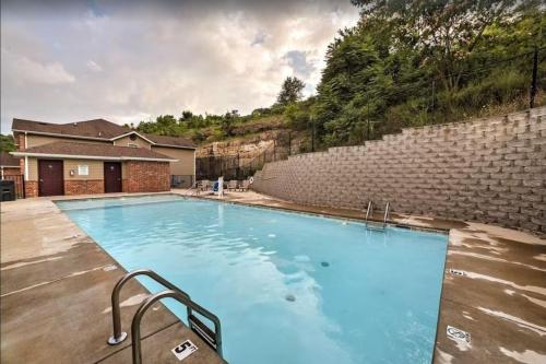 a large blue swimming pool next to a brick wall at 3BR Branson Condo PrimeLocation! in Branson