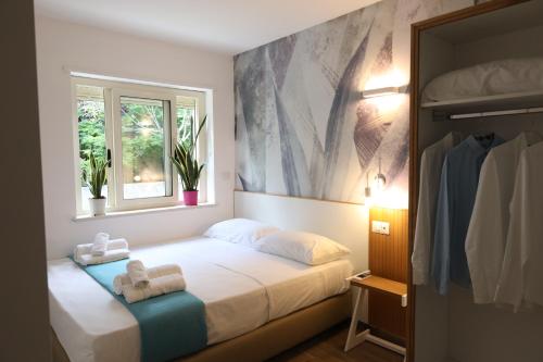 a bedroom with a bed with towels on it at SUNSEA - Enjoy Your Family in Capo Vaticano