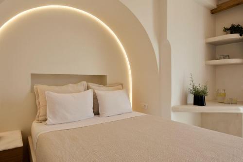 a bedroom with a large bed with an arched ceiling at Hermes Hotel in Kamari