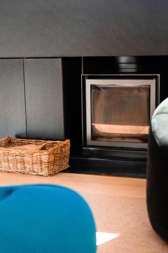 a living room with a fireplace and a couch at Péniche de prestige à Namur avec vue sur la Citadelle - A l'Abordage - By Voyages Copine in Namur