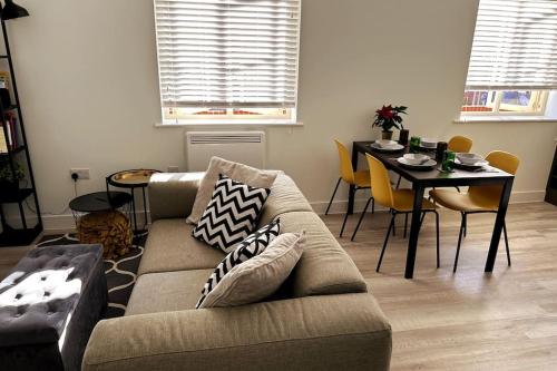 a living room with a couch and a table at Stylish and Modern One-Bedroom Flat in Dorset in Parkstone
