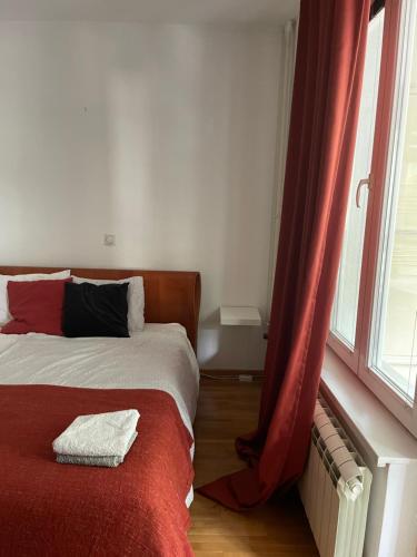 a bedroom with a bed and a window at Belgrade with love in Novi Beograd