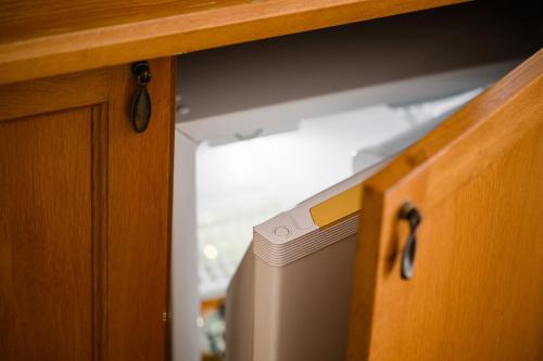 a small refrigerator in a kitchen with a wooden cabinet at Bogolvar Retreat Resort in Antonovka