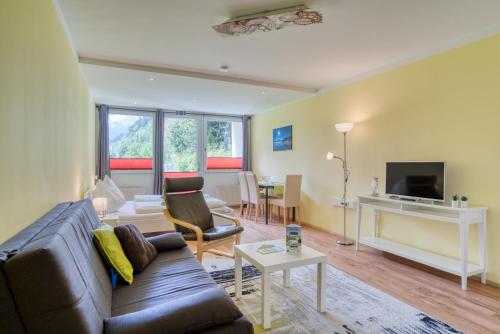 a living room with a couch and a tv at Apartment Annemarie in Zell am See