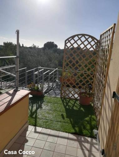 a balcony with potted plants and a fence at Casa Cocco in Sant' Isidoro