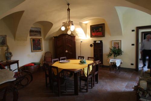 a dining room with a table and chairs at Casa della Sofora in Bene Vagienna