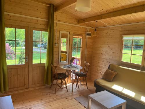 a living room with a couch and a table at Domki Radków in Wünschelburg