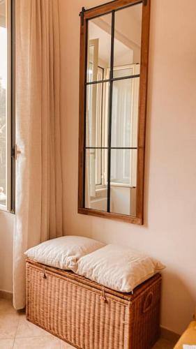 a mirror sitting on top of a wickerasket in a room at Locazione turistica Davide in Anzio
