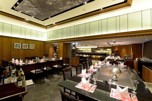 a dining room with tables and chairs in a restaurant at Brother Hotel in Taipei