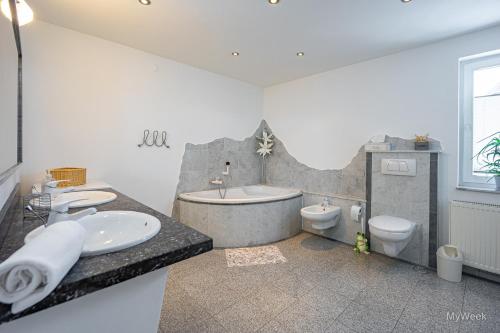 a bathroom with a tub and a sink and a toilet at Dom Artysty, MyWeek in Bystrzyca Kłodzka