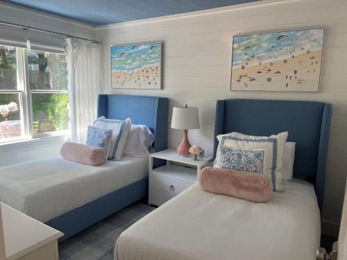 a bedroom with two beds with blue headboards at Edgartown Commons Vacation Apartments in Edgartown