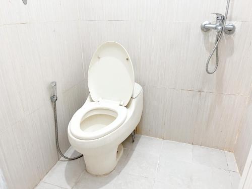 a bathroom with a white toilet in a stall at OYO Life 92630 Siliwangi Residence 63 in Bandung