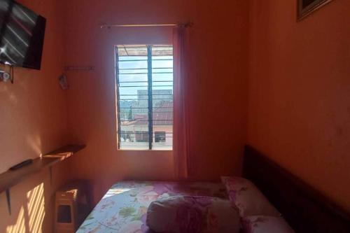 a small bedroom with a bed and a window at OYO 92631 Hotel Dan Aula Wahyu Sari B in Karanganyar