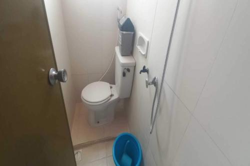 a small bathroom with a toilet in a stall at OYO 92631 Hotel Dan Aula Wahyu Sari B in Karanganyar