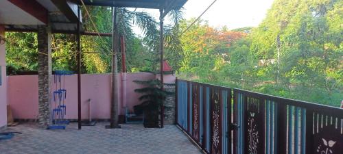 a balcony of a house with a bunch of books at JEENA Homestay VILLA in Kollam