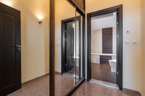 ein Badezimmer mit Glasschiebetüren und einem WC in der Unterkunft MareliS Skies VIP Apartment in Topola
