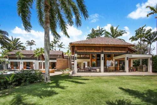 ein Haus mit einem Pavillon auf einem Hof mit Palmen in der Unterkunft Las Palmas 22 Ocean View Villa with Cook Butler Maid in La Romana