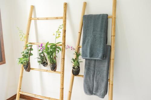 a pair of bamboo towel racks with potted plants at Cliff Haven Villa Krabi in Ao Nang Beach